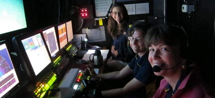 people working in dark control room
