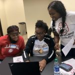 Kids studying coding at camp